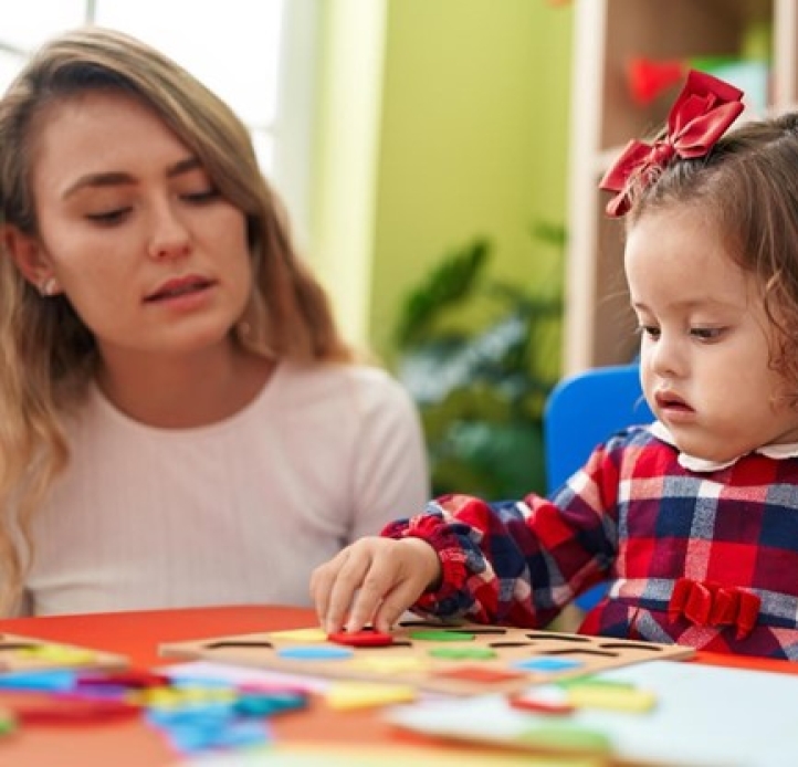Teacher and child with a puzzle